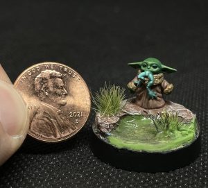 Painted Yoda mini next to Penny